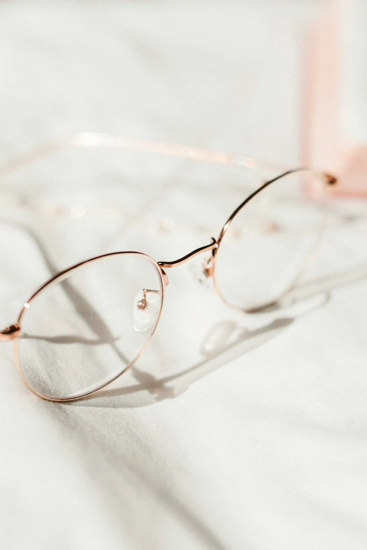 Silver framed eyeglasses on white textile